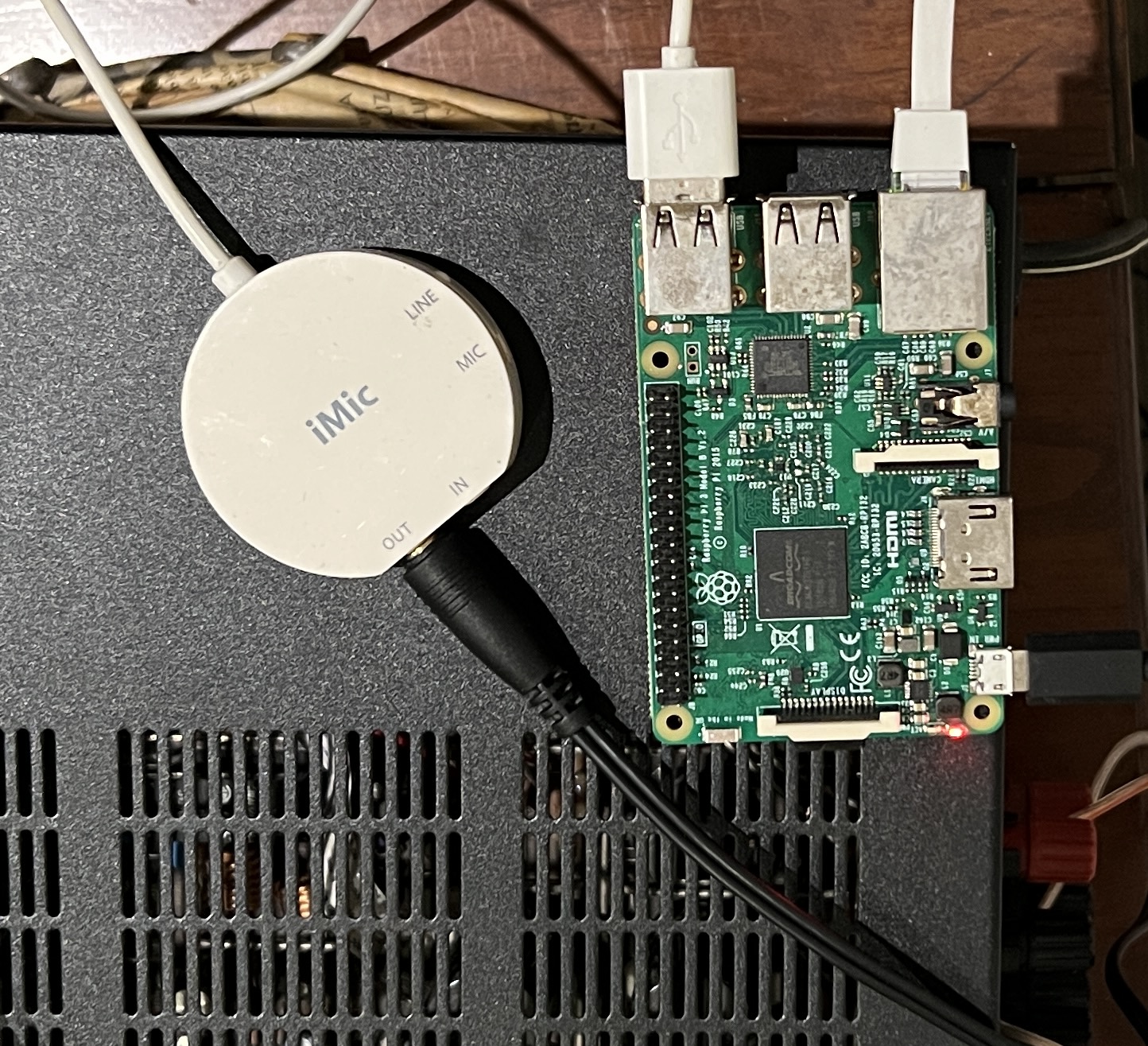 A photo of the Pi plugged into a USB DAC, which is then plugged into a 3.5mm audio jack.